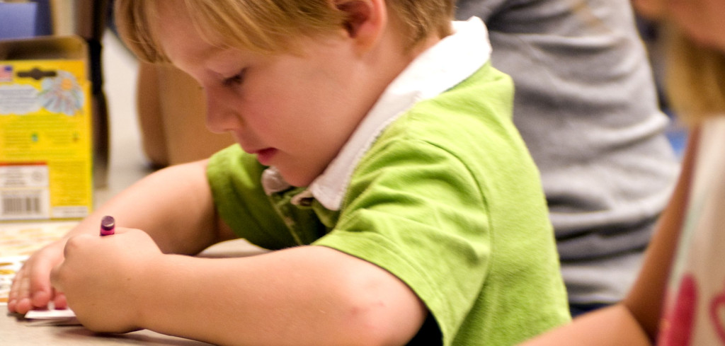 Children were seated at a table putting their creativity to work