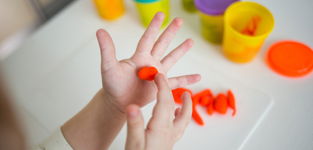 little girl sculpts from plasticine. small child shapes of soft clay.