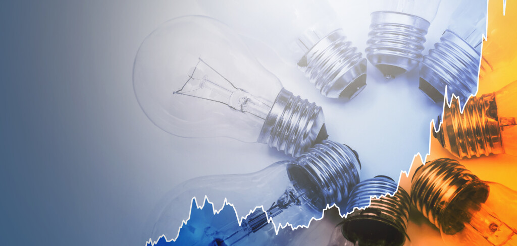 Light bulbs and rising sparkline chart representing current high electricity price during energy crisis in the world