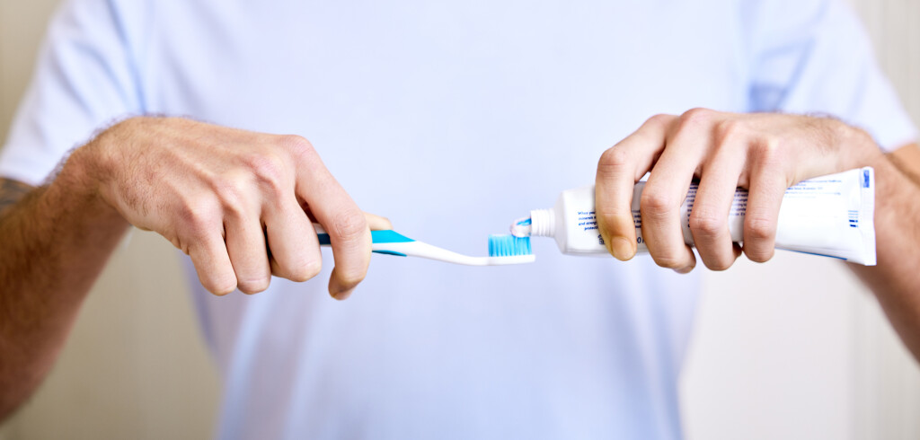 Shot of a man applying toothpaste to his toothbrush.